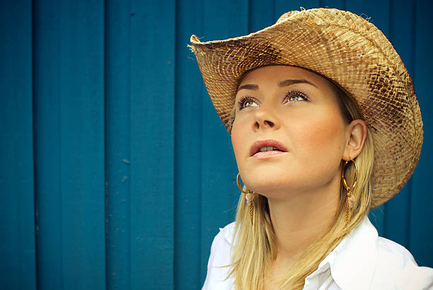 Attractive girl in a cowboy hat with long hair