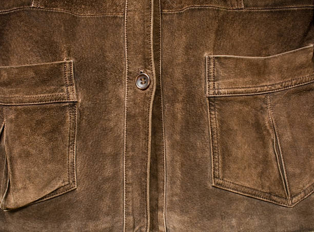 Brown suede jacket Close-up of button and pockets on old brown suede jacket. leather pocket clothing hide stock pictures, royalty-free photos & images