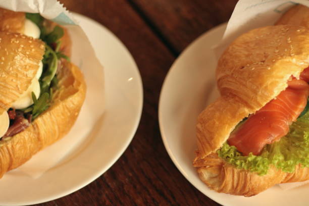 istock two croissants with mozzarella and prosciutto and with salmon on a white plate 1722470608