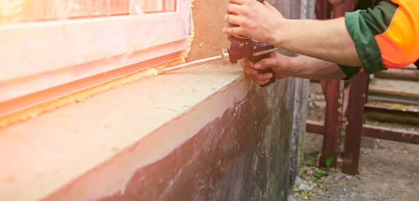 istock A construction worker sticks sealing foam tape on a window in a house. 1722471270