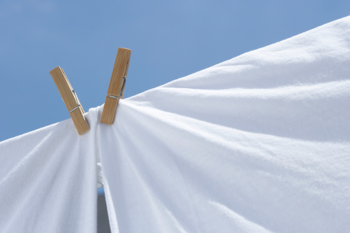 Laundry white sheets on clothesline.