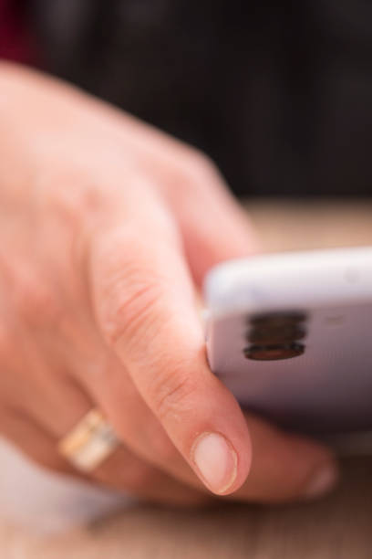 istock Woman's hand consulting a mobile phone with selective focus 1722479638