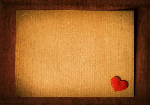Vignetting Photo of Red Heart Shape on the Old Paper closeup