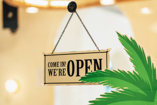 Welcome, we're open sign on a glass door