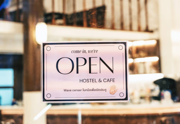 View through window of open sign in shop