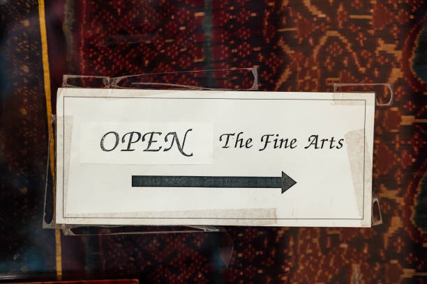 View through window of open sign in shop
