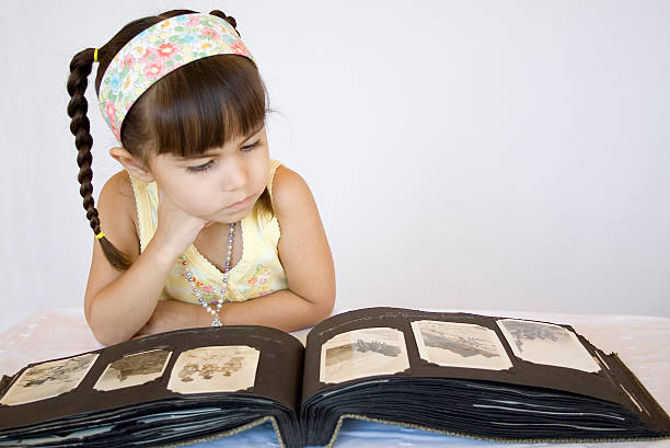 istock Child looking intently at Old Photos 172248246