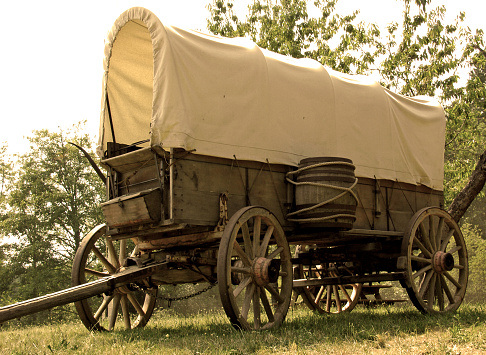 Old sepia colored western covered wagon.