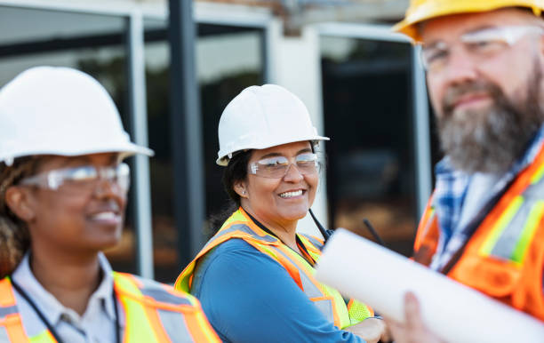 istock Hispanic woman leading group of construction workers 1722485989