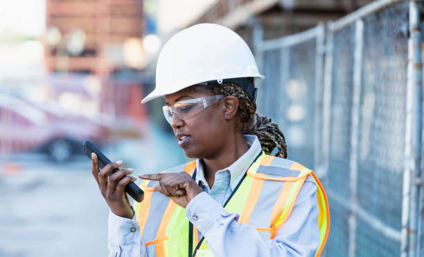 istock Female African-American construction worker on mobile phone 1722486001