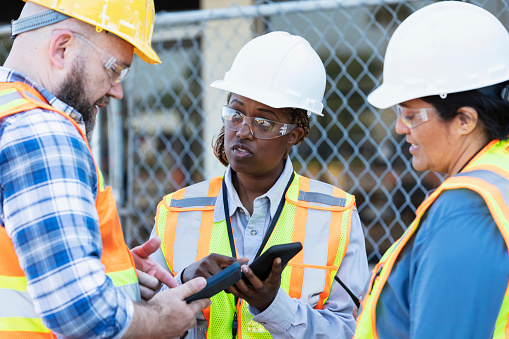Worker Using Phone Three Construction Workers Meet Using Mobile Phones Stock Photo ...