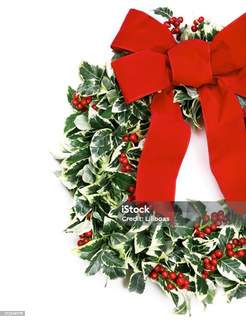 Holly Wreath A wreath of holly and a red bow. Berry Stock Photo