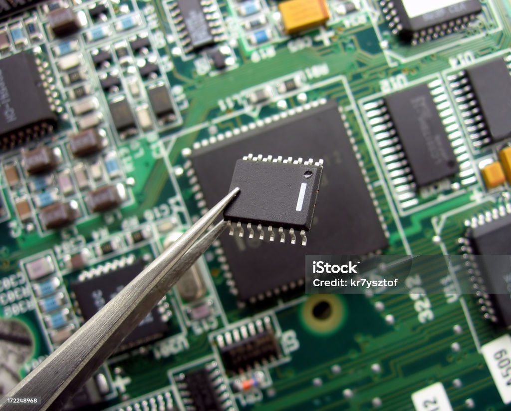 Electronic Close-up of an integrated circuit.Electronics lightbox: Tweezers Stock Photo