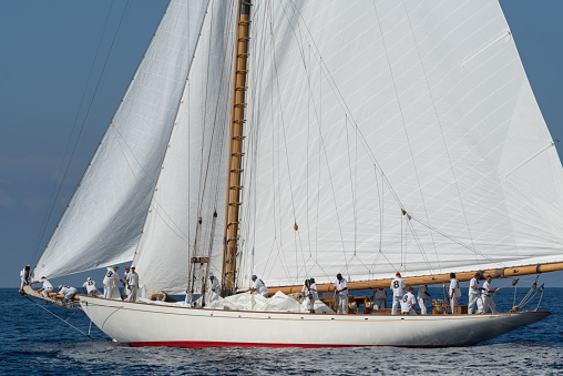 Imperia, Italy - September 7, 2018: Crew members aboard on sailboat the old style, during regatta in Gulf of Imperia. Established in 1986, the Imperia Vintage Yacht Challenge Stage is a of the most important event in sailing the Mediterranean dedicated to historical boats