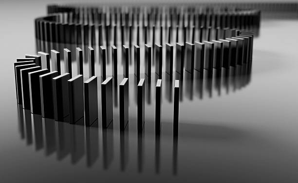 Blank domino pieces set up to fall over in a chain reaction stock photo