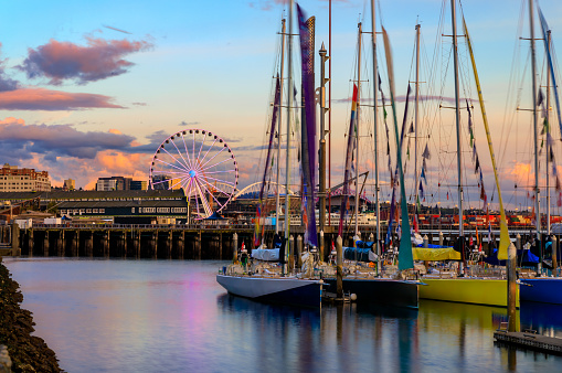 Seattle downtown waterfront buildings and sail boats docked on Puget Sound at sunset Seattle, Washington, United States