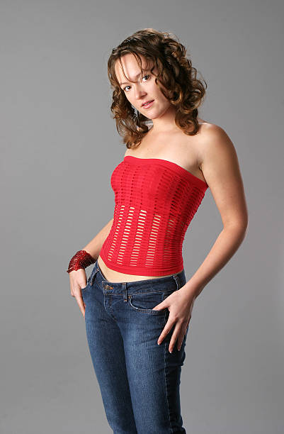 istock Young woman with thumbs in pockets 172250514
