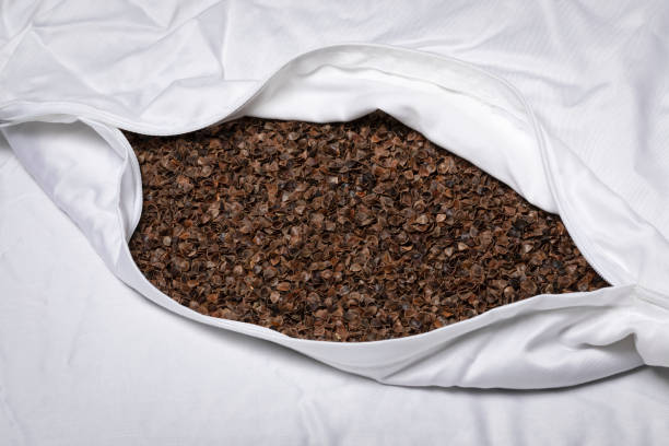 Pillow case stuffed with buckwheat hulls isolated on white background