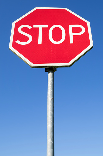 Dutch road sign: STOP, give priority to traffic on the main road ahead,