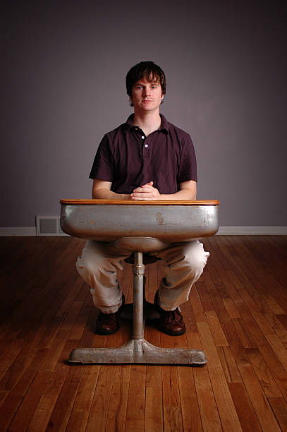 istock Young Man Student Sitting in Old School Desk 172250967