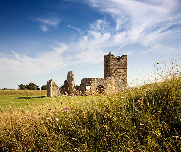 Knowlton Church, Dorset The remains of this Norman Church sit in the middle of an earth circle dating from 2500 BC. This image is unsharpened and there is some motion blur in the foreground grass. knowlton stock pictures, royalty-free photos & images