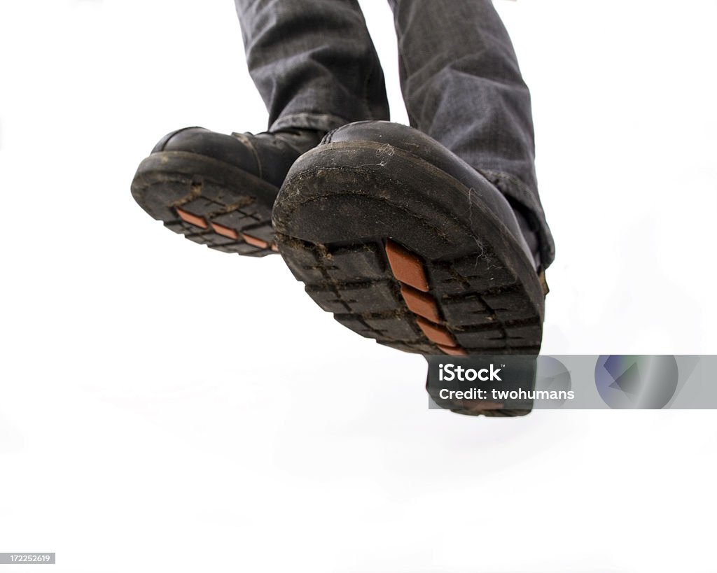 Active feet - Biker boots Close-up of a pair of black biker boots. Concepts: jumping, active, rebellion, step, toughness, in your face. Studio photography, isolated on white background. Jumping Stock Photo