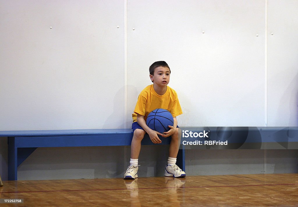 Waiting for the Game a boy on the bench Boys Stock Photo