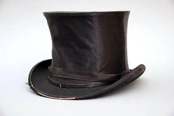 "worn out, black top hat"