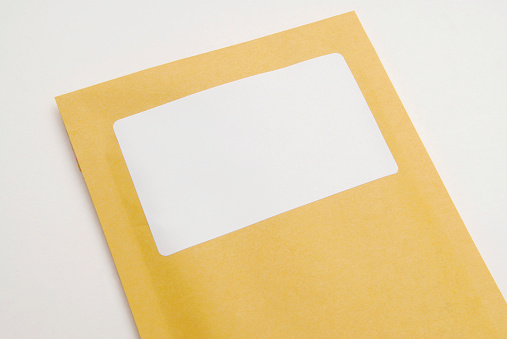 Manila envelope with blank white label