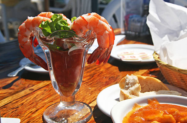 Fresh caprese salad with cherry tomatoes, mozzarella, basil leaves and grilled shrimps. Flat lay. Top view with copy space