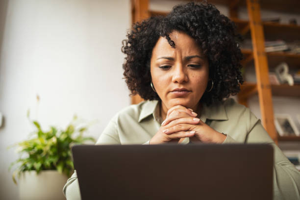 istock Frustrated Latin woman using laptop at home 1722564865