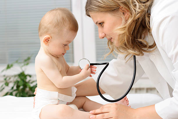 istock Pediatrician playing with baby patient 172256553
