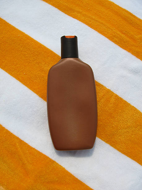 Various sunsreen products in the sand