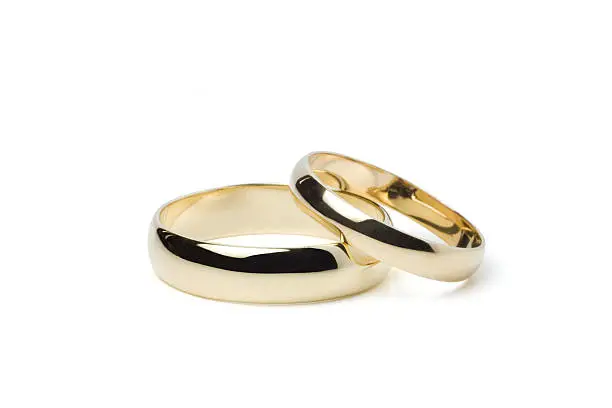 His and hers classic gold wedding bands on white with clipping path.