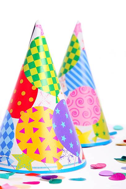istock Two colorful party hats and confetti on vertical white background 172257138