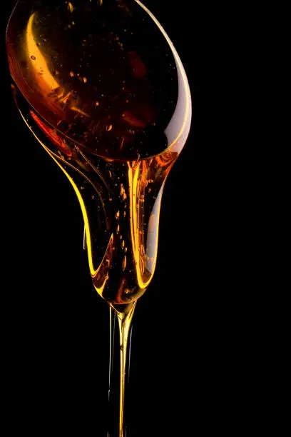 golden syrup dripping from a spoon
