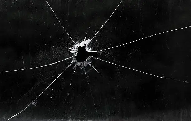 Photo of A bullet hole in a glass window