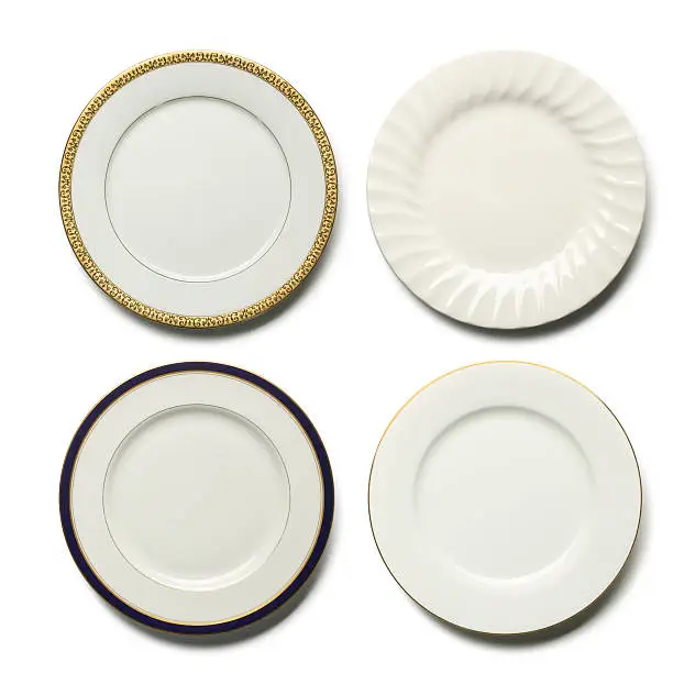 Four elegant dinner plates om white with soft shadow. Place your own food on plate