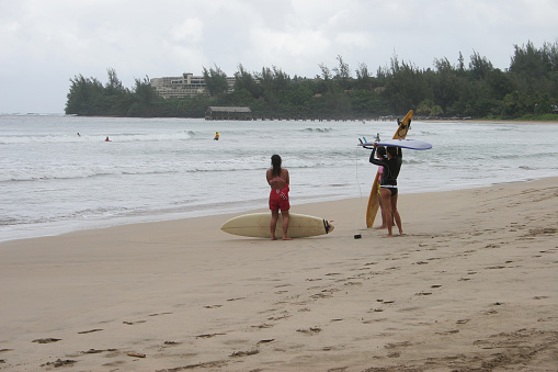 3 surf girls at Kauai, Hawaii.