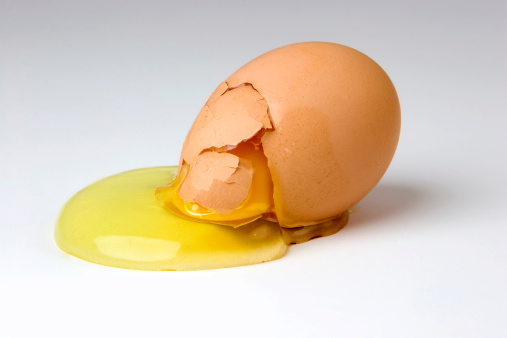 A broken egg with the yoke spilling out