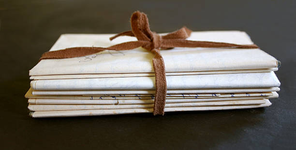 stack of faded letters tied up with a strip of suede