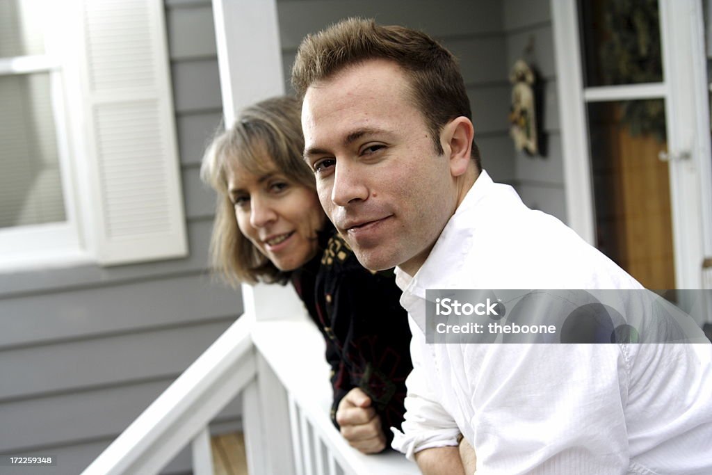 mother and son looking at you mom and son hanging out on the front porch Number 45 Stock Photo