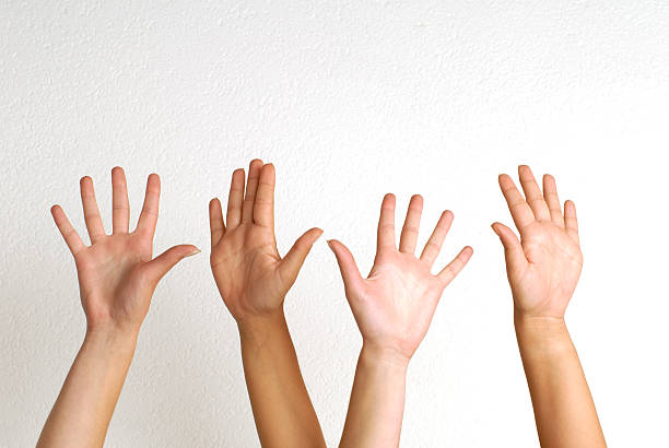 White people raising their hands  stock photo