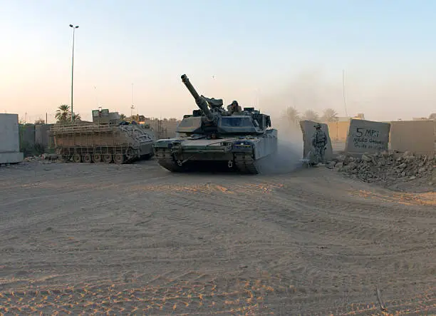 "M1 Abrams Main Battle Tank crew prepares for combat patrol in Ramadi, Iraq."