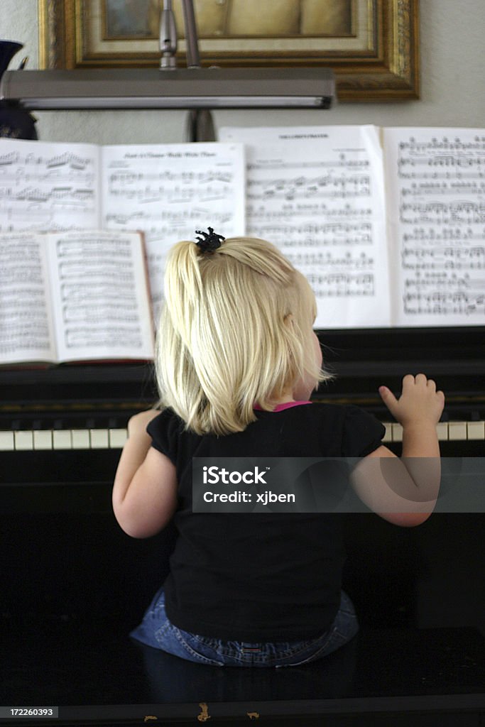 Piano Girl Adorable young girl playing the piano. Piano Stock Photo