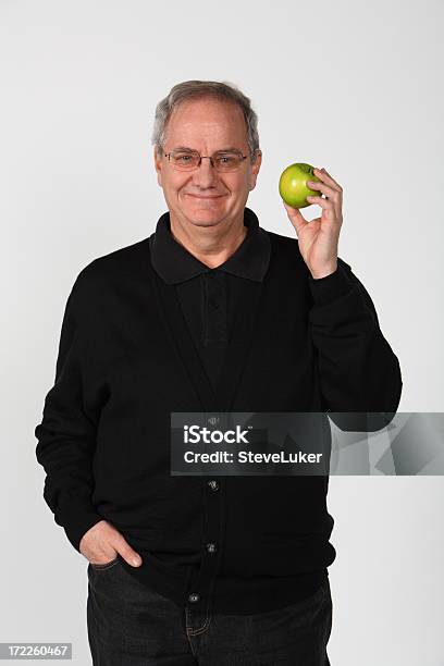 Man Holding Apple Stock Photo - Download Image Now - Active Seniors, Adult, Adults Only