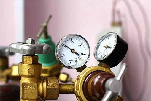 Flow regulator to reduce the pressure of gas coming from the cylinder, gas pressure gauge in production. Selective focus.
