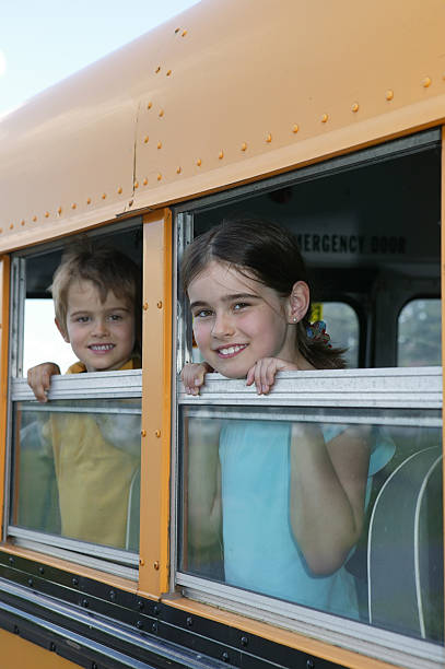 istock boy and girl in school bus 172261132