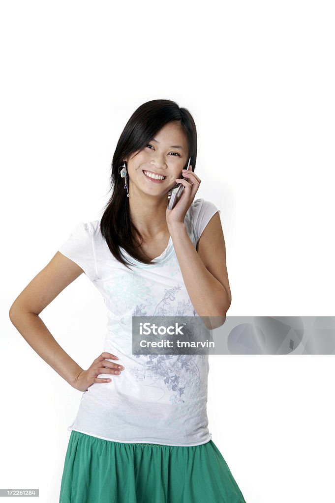 Asian on the cell phone A young Asian woman talks on her cell phone. Adult Stock Photo