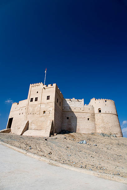Desert Fortress United Arab Emirates "Fujairah Fort against deep blue sky, City of Fujairah,UAE" fujairah stock pictures, royalty-free photos & images